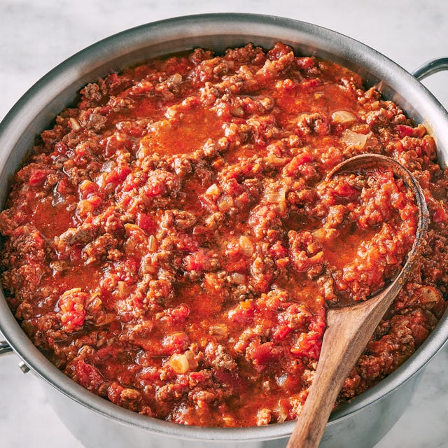 spaghetti sauce with ground beef crushed tomatoes parmesan rind and basil
