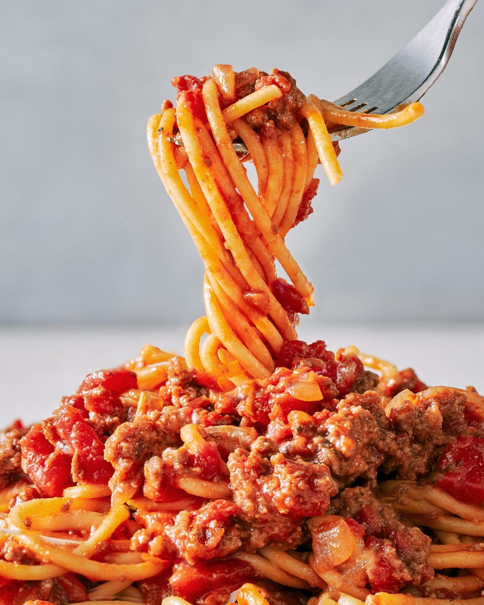 spaghetti sauce with ground beef crushed tomatoes parmesan rind and basil