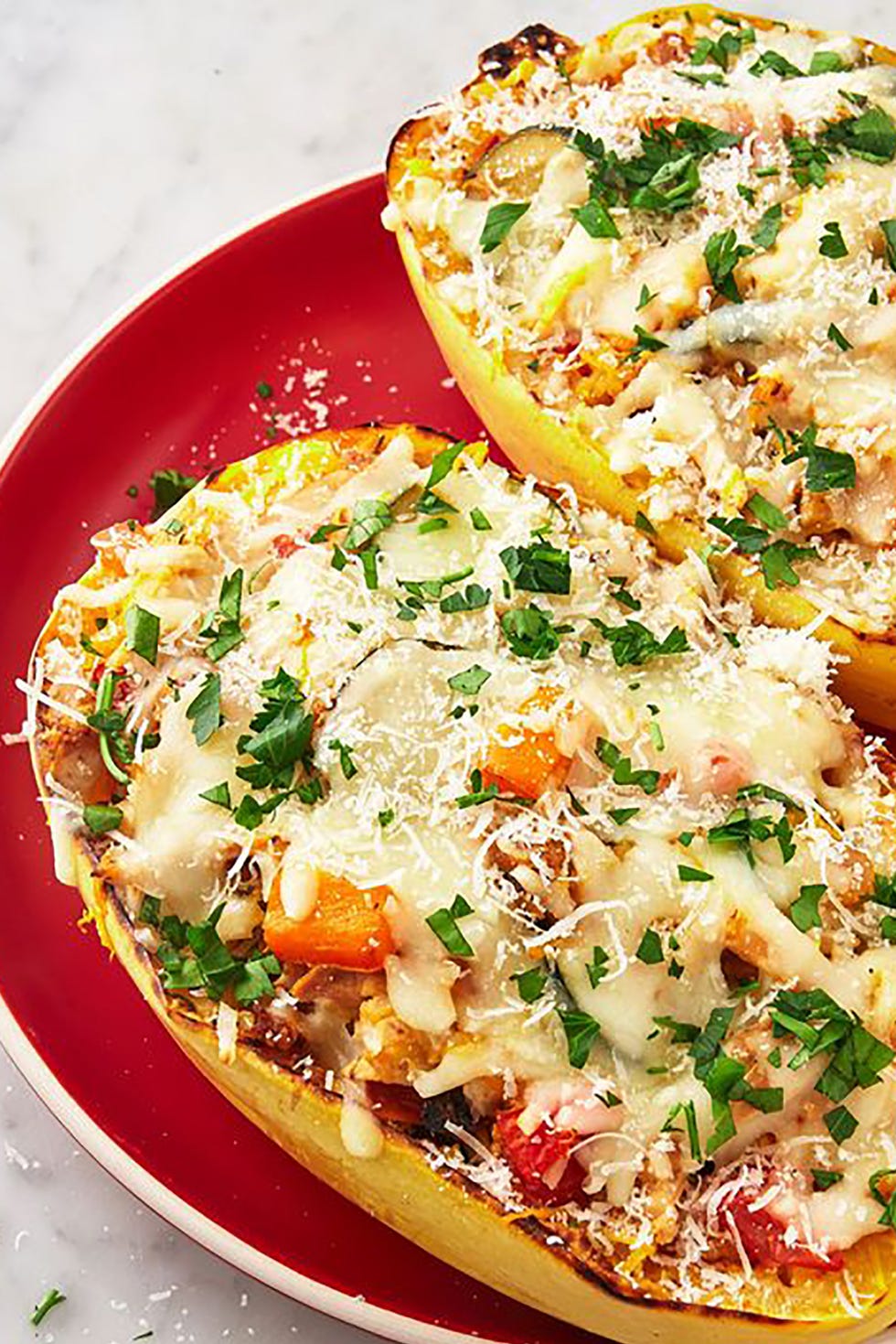 loaded spaghetti squash boats on a red plate