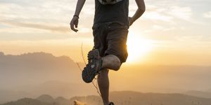 spain, barcelona, natural park of sant llorenc, man running in the mountains at sunset
