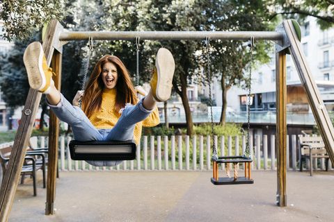 young woman on a swing in the park