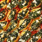 spanakopita stuffed shells filled with spinach, scallions, dill and feta