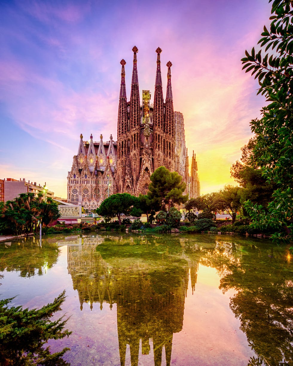 spanish cities barcelona la sagrada familia sunset clouds blue hour flare