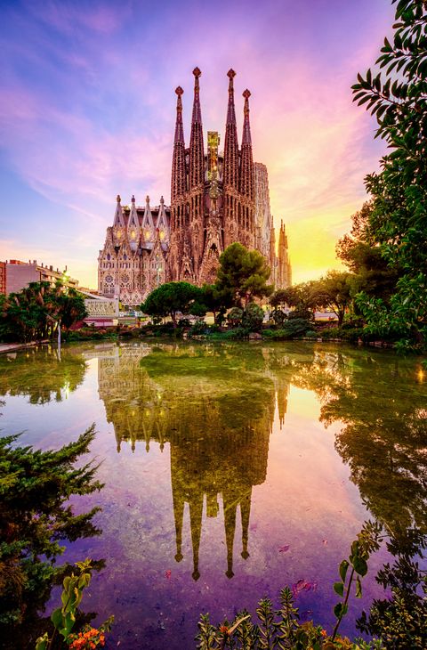 spanish cities barcelona la sagrada familia sunset clouds blue hour flare