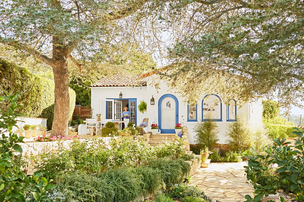 spanish colonial house style with blue door and window trim