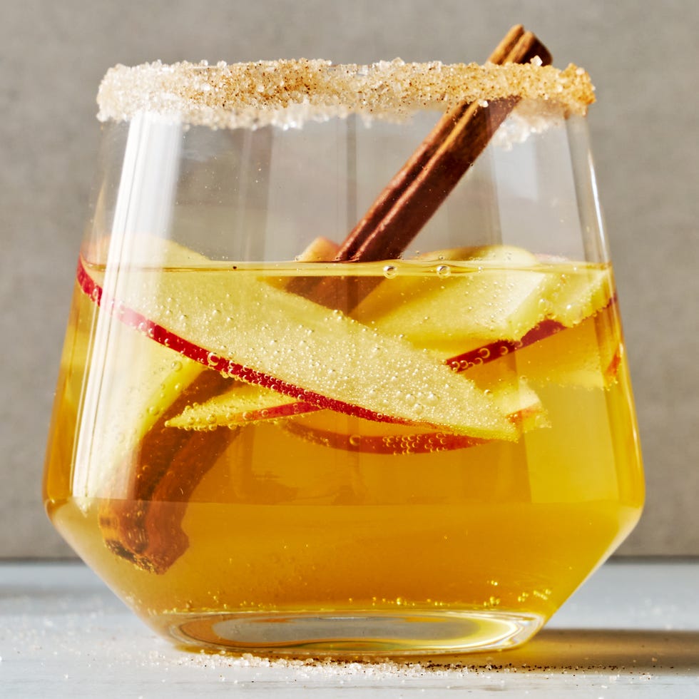 sparkling apple cider sangria with apple slices and cinnamon sticks