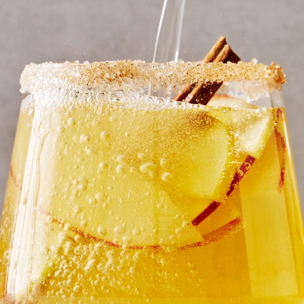 sparkling apple cider sangria with apple slices and cinnamon sticks