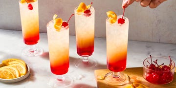 sparkling tequila sunrise with a cherry and orange peel
