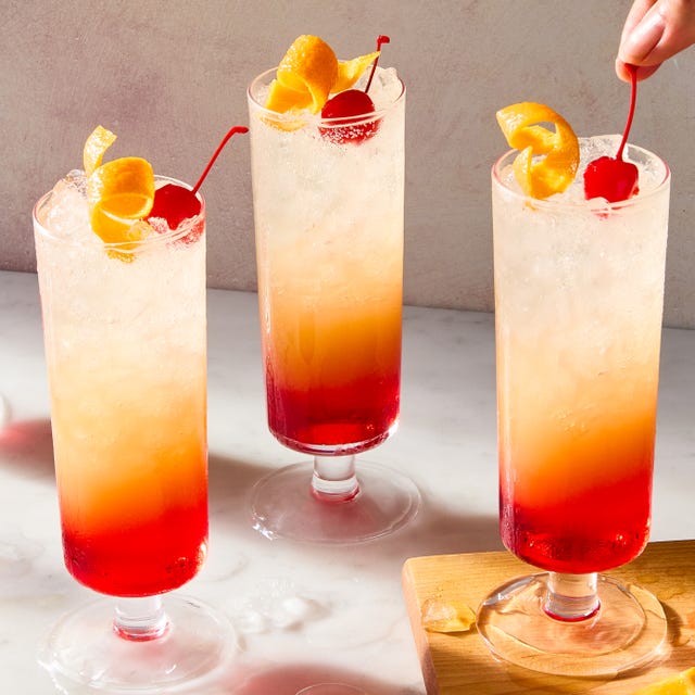 sparkling tequila sunrise with a cherry and orange peel