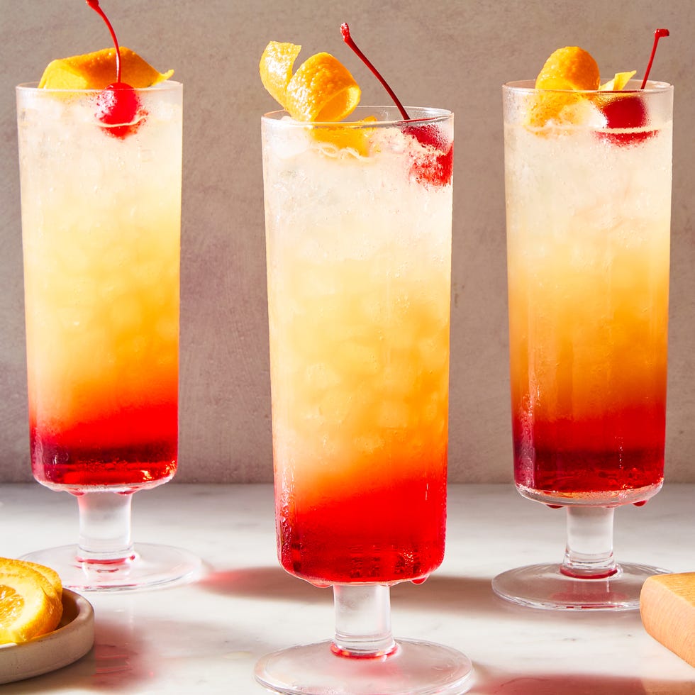 sparkling tequila sunrise with a cherry and orange peel