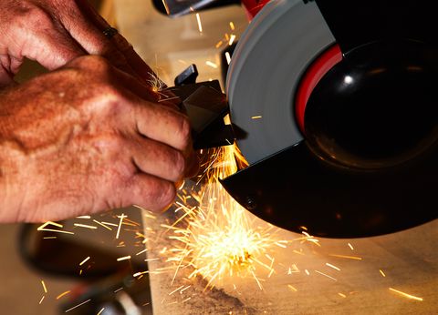 using a bench grinder with sparks flying