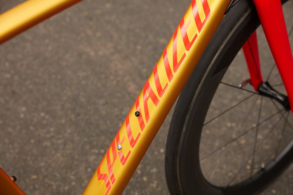 Bicycle part, Bicycle tire, Bicycle wheel, Bicycle frame, Bicycle, Spoke, Orange, Vehicle, Yellow, Bicycle fork, 