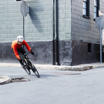 a person riding a bicycle around a corner