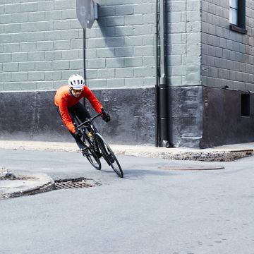 a person riding a bicycle around a corner