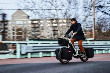 man riding specialized globe haul st cargo bike on city street