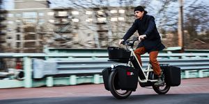 man riding specialized globe haul st cargo bike on city street