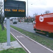 speeding taffic passing a variable message safety sign west london, united kingdom