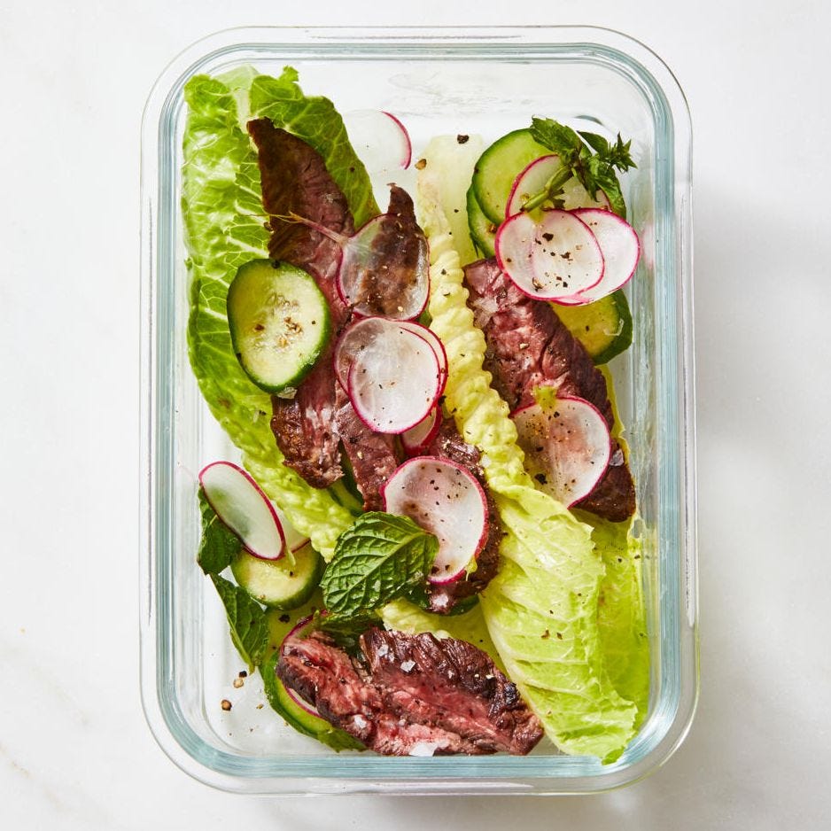 spice grilled steak spring salad with sliced radish and cucumber in a glass container