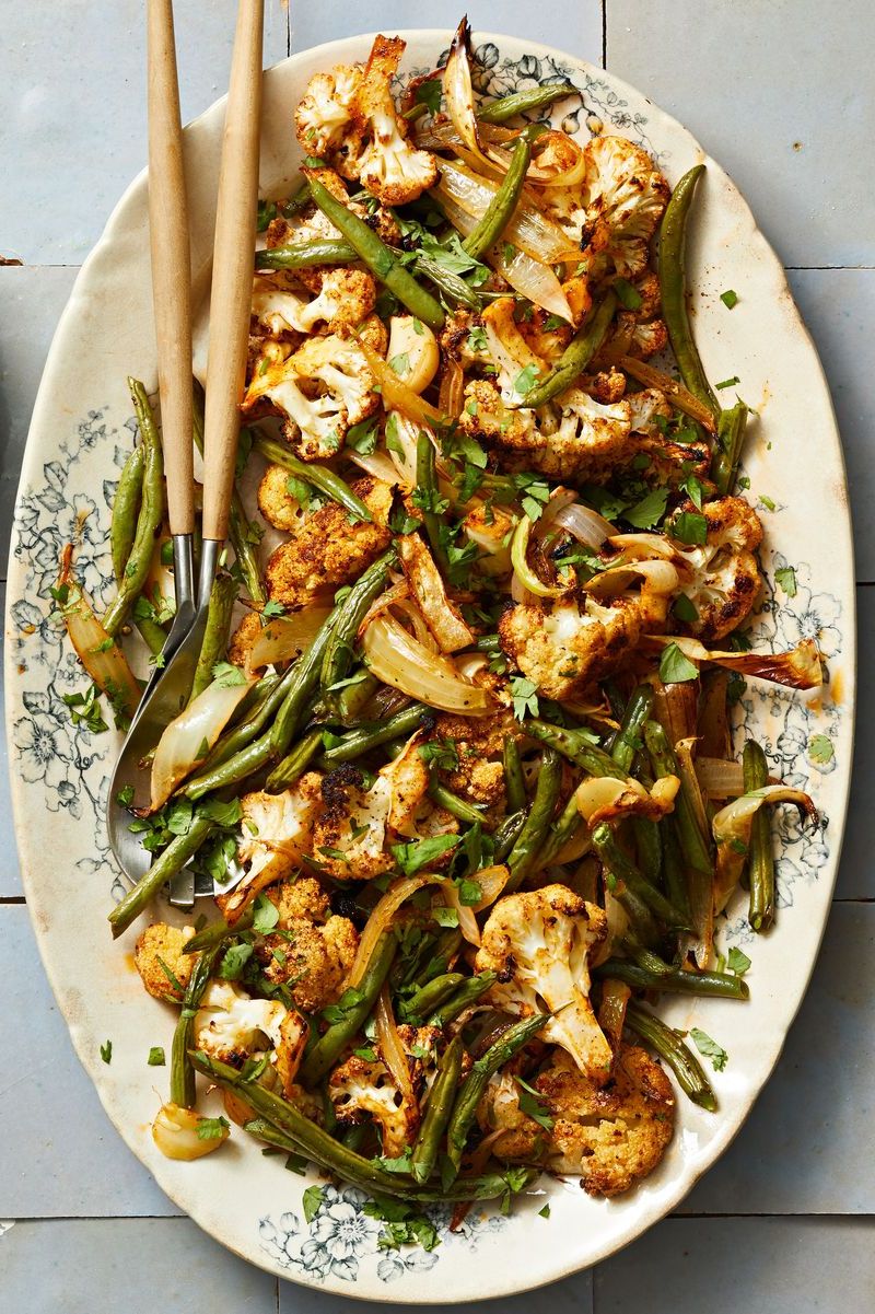 spice roasted cauliflower with green beans on a serving platter