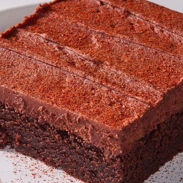 frosted hot chocolate brownies with a spice mix dusting on top