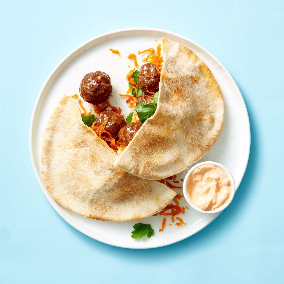spiced meatball pitas with crispy carrot slaw on a white plate