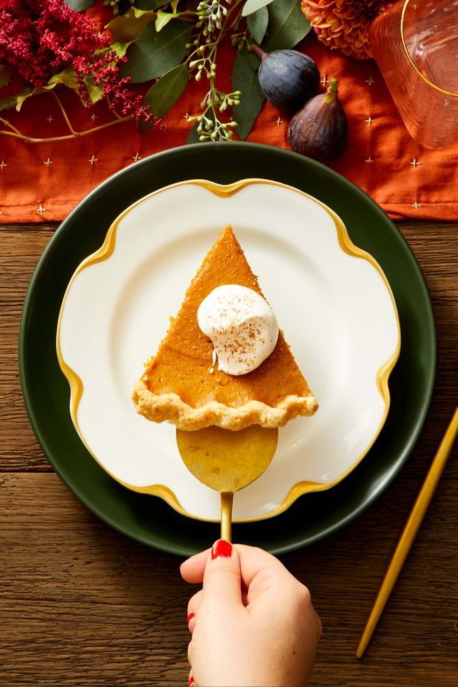 a slice of spiced pumpkin pie with whipped cream on top