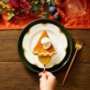 a slice of spiced pumpkin pie with a dollop of whipped cream on top