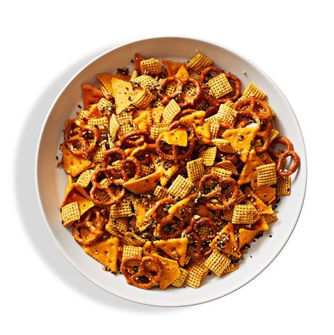 a bowl spiced snack mix that includes pretzels, chex mix, crackers and more