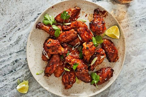 spicy apricot glazed wings on a white speckled plate