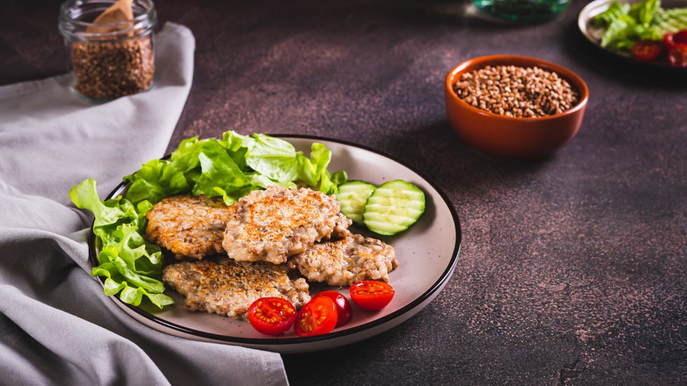 spicy buckwheat pancakes with slices of cucumber, tomato and lettuce on a plate web banner