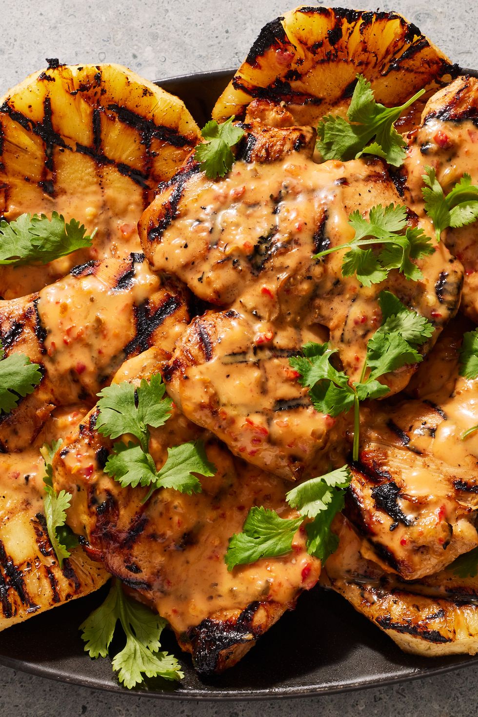 https://hips.hearstapps.com/hmg-prod/images/spicy-coconut-grilled-chicken-2-1672870819.jpg?crop=0.9059089973234508xw:1xh;center,top&resize=980:*