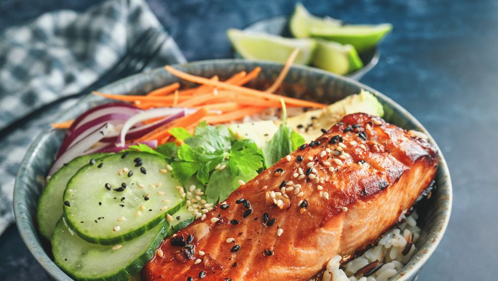 spicy salmon bowl with rice, carrots, cucumber and avocado