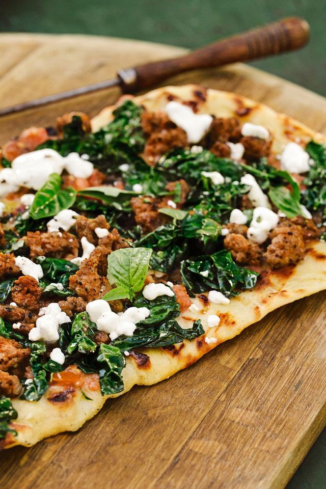 christmas appetizers spicy sausage, kale, and goat cheese pizza