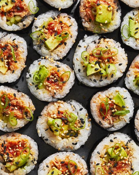 spicy tuna roll with scallions and sesame on top