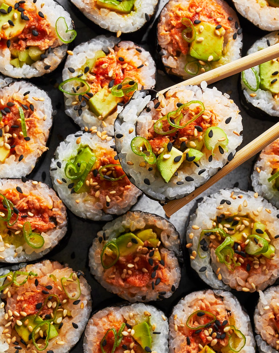 spicy tuna roll with scallions and sesame on top