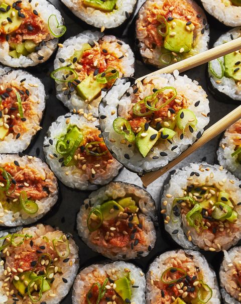 spicy tuna roll with scallions and sesame on top
