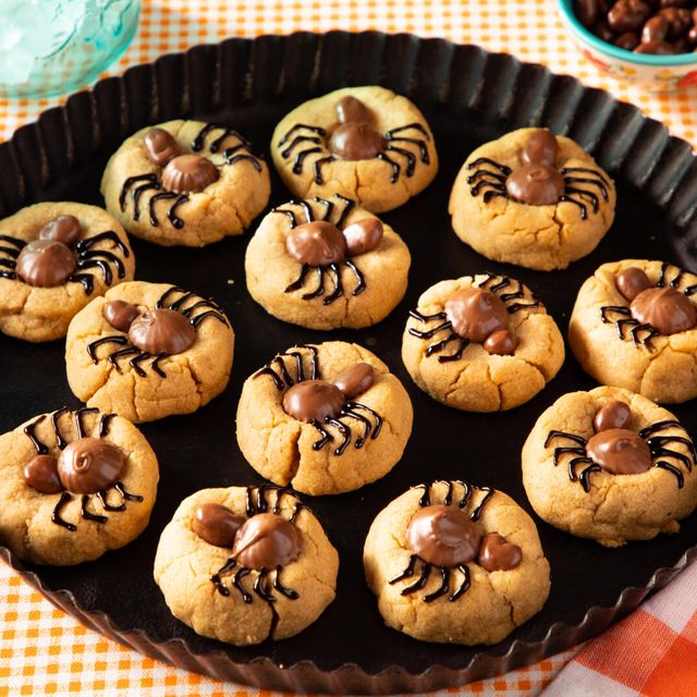 peanut butter cookies topped with candies and icing to look like spiders