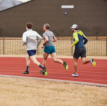 a group of men running Knee on a track