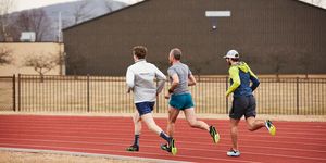 a group of men running Chaussures on a track