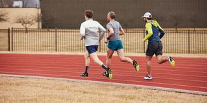 a group of men running icon on a track