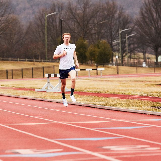 a runner running fast on a track