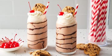 chocolate egg cream topped with whipped cream, a cherry, and a chips ahoy cookie