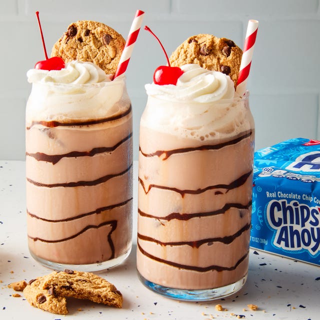 chocolate egg cream topped with whipped cream, a cherry, and a chips ahoy cookie