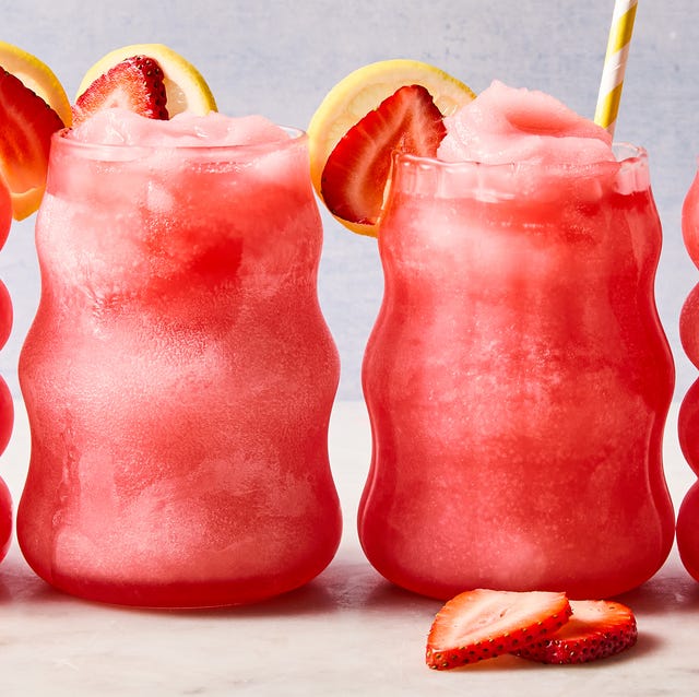 Spiked Pink Lemonade Slushies spiked pink lemonade slushies with sliced strawberries and lemon
