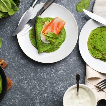 spinach crepes with smoked salmon and sour cream, top view