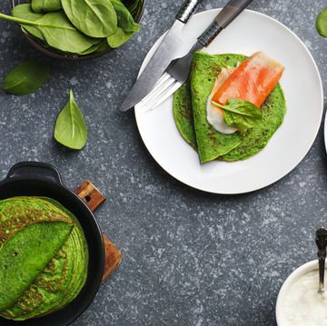 spinach crepes with smoked salmon and sour cream, top view