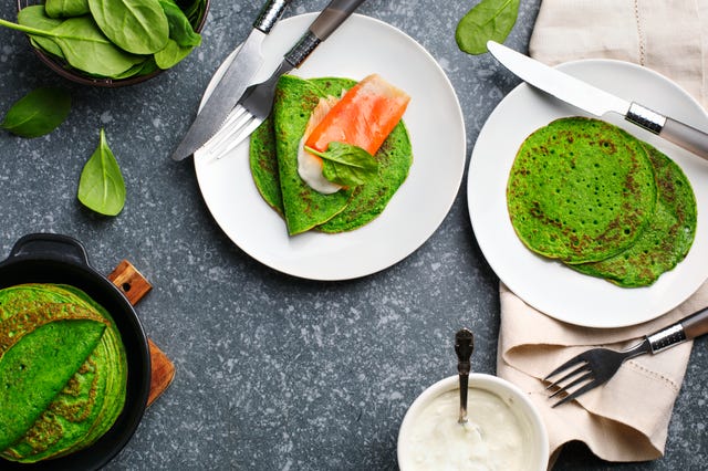 spinach crepes with smoked salmon and sour cream, top view