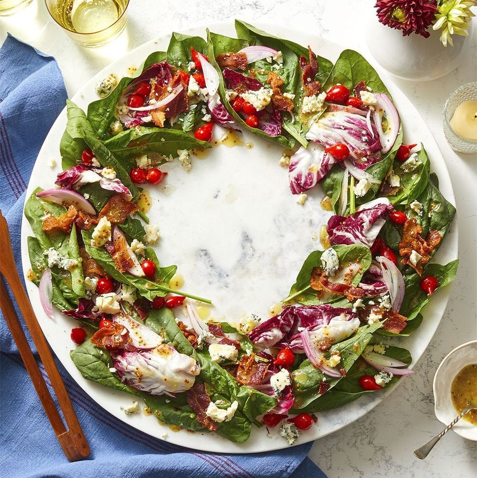 spinach salad with pickled shallots and mustard vinaigrette in the shape of a wreath