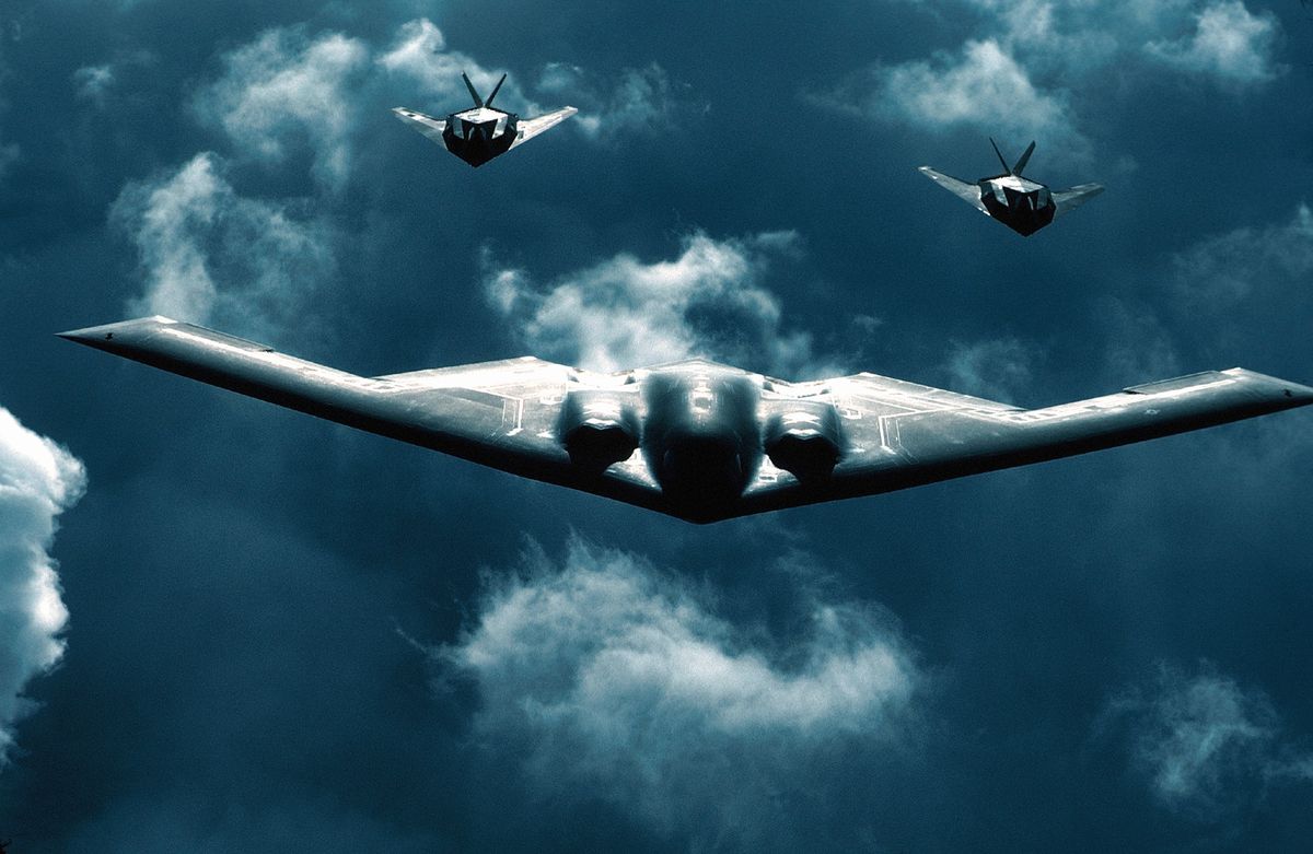 b 2 bomber flies with two f 117 jets