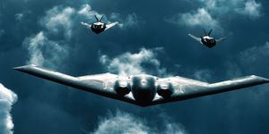 b 2 bomber flies with two f 117 jets